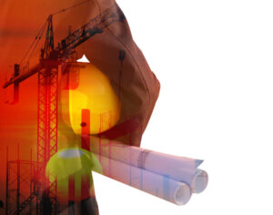 an engineer holds a hardhat and blueprints thinking happy thoughts
