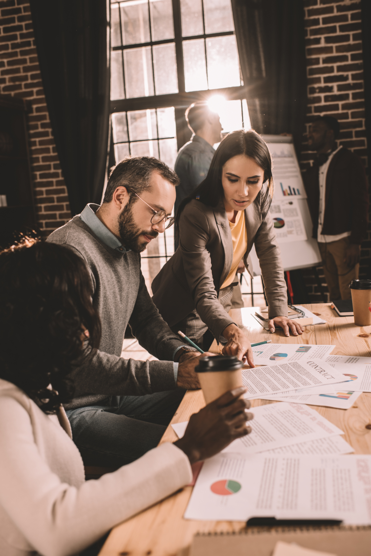 business executives looking at spreadsheets photo