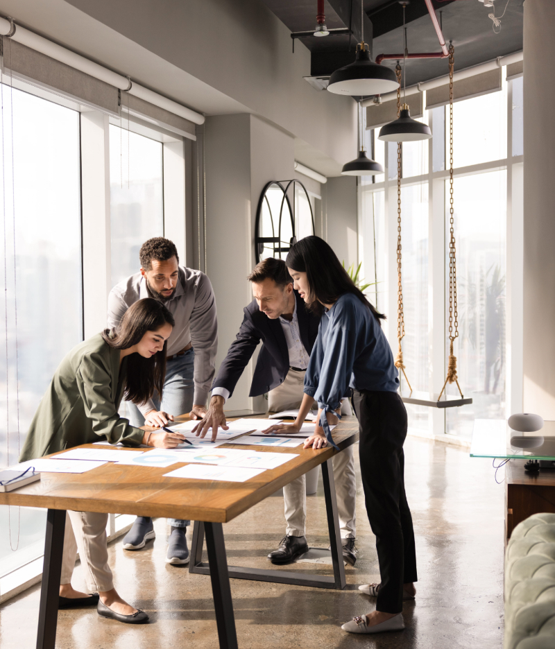 A leadership team gathers in a conference room to review potential expansion locations photo